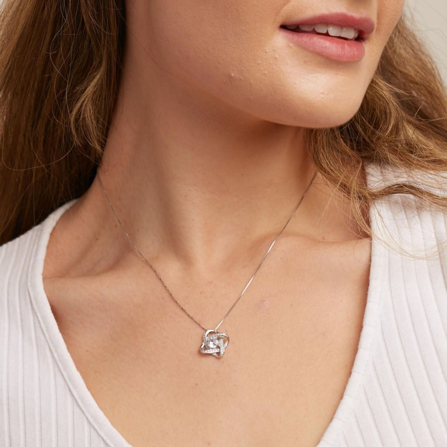 Woman wearing the Love Knot Necklace, a sentimental gift for mom