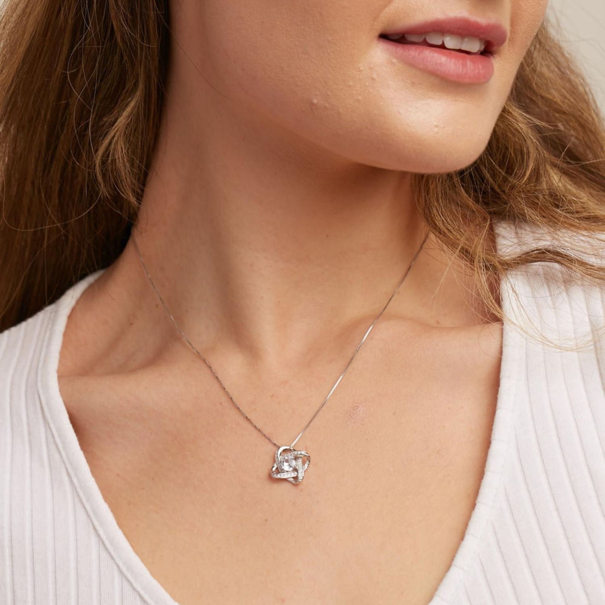 Woman wearing the Love Knot Necklace, a sentimental gift for mom