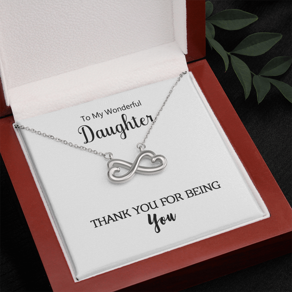 Close-up of the heart-shaped infinity pendant