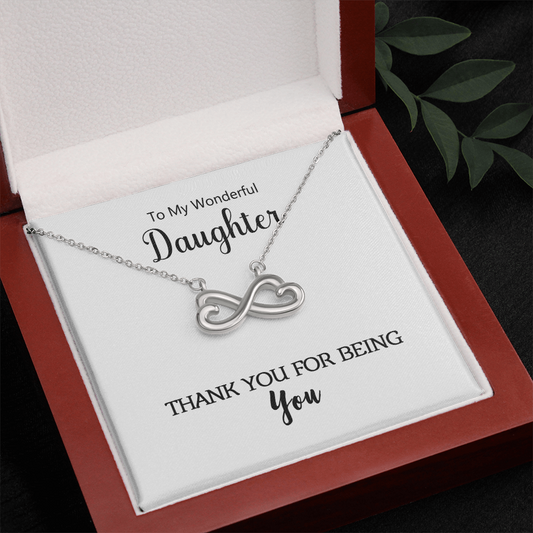 Close-up of the heart-shaped infinity pendant