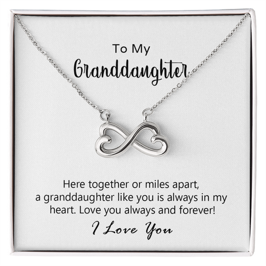 Close-up of the heart-shaped infinity pendant